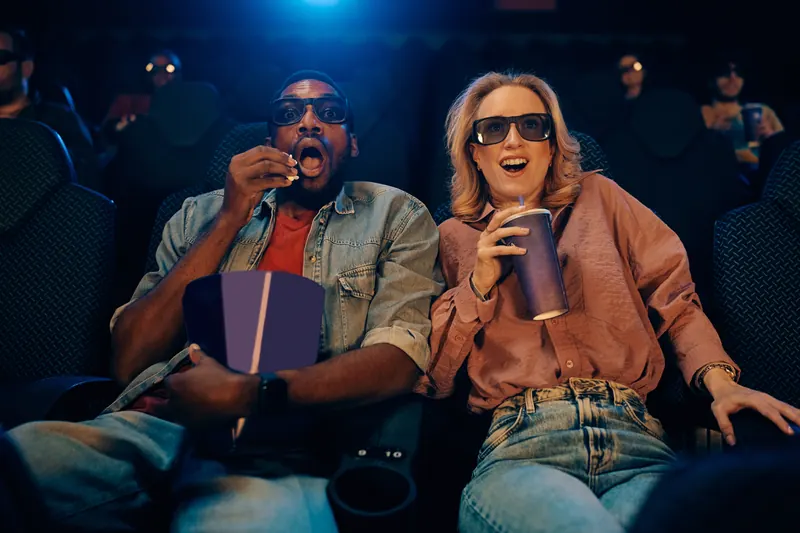 A couple watching a film in 3D glasses