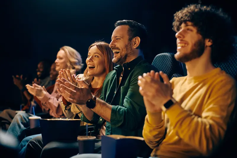 A cinema audience laughing and applauding