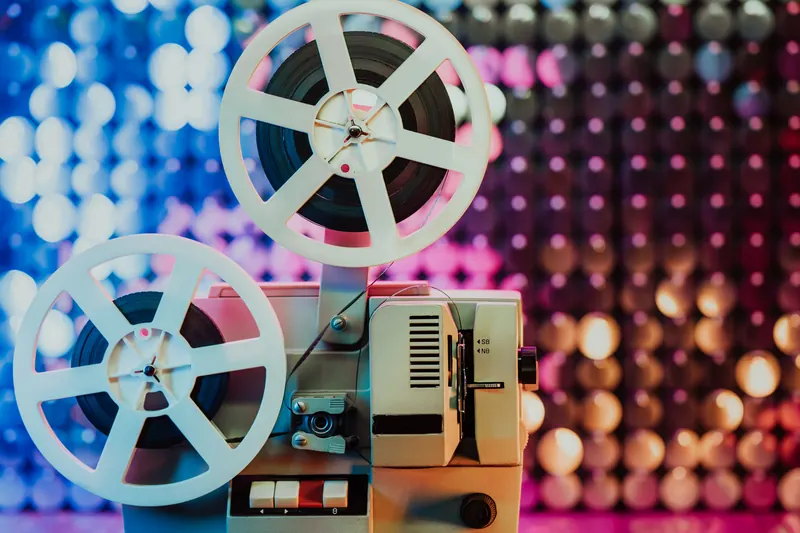 Film reels against a glittering backdrop