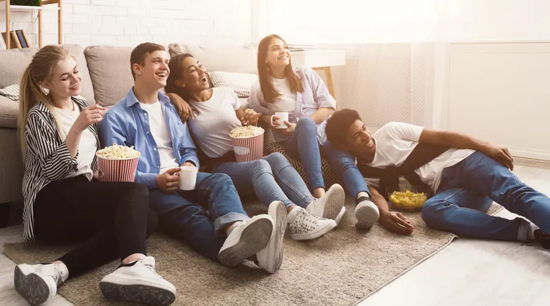 Friends settling in for a night in front of the screen