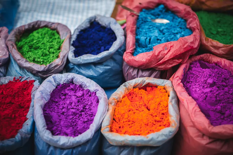 Sacks of bright coloured powder at a market