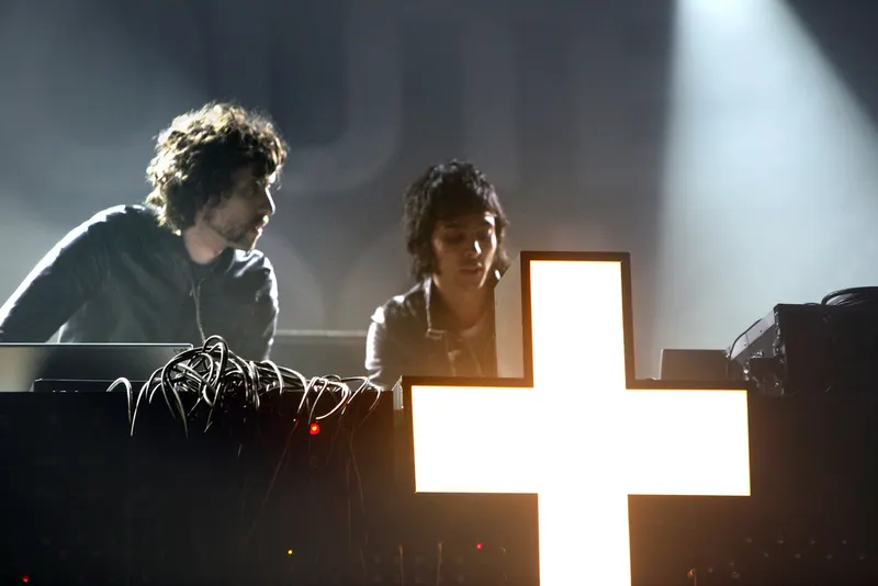 The two members of French duo Justice on stage behind their illuminated cross