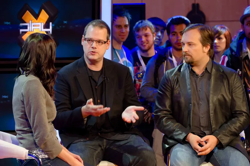 BioWare co-founders Ray Muzyka and Greg Zeschuk seated during a televised interview