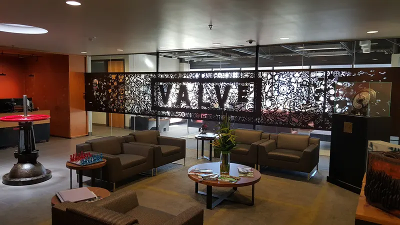 Valve lobby with lounge chairs and a decorative Valve logo screen