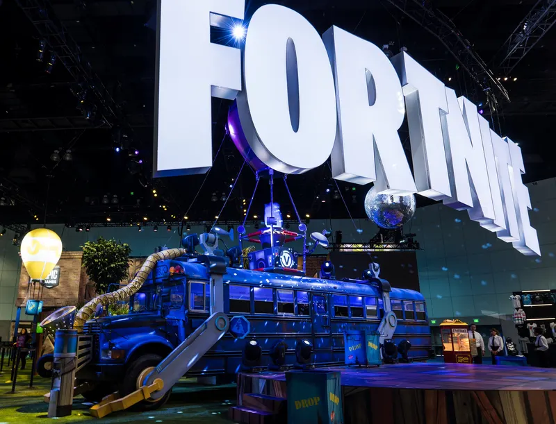 Giant Fortnite lettering above the blue Battle Bus display at E3