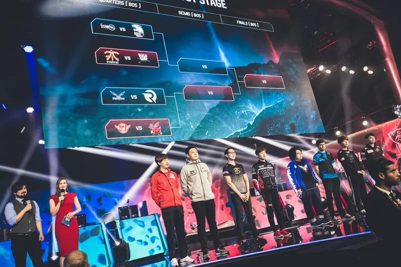 Teams lined up on stage beneath a large knockout bracket screen at Worlds 2015