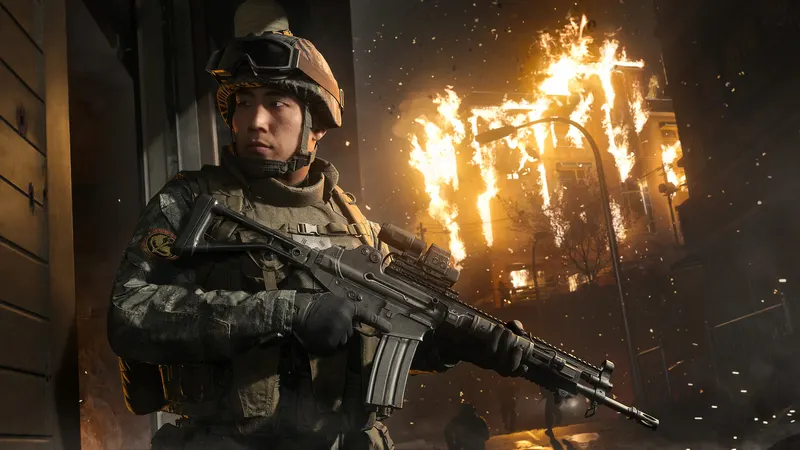 A soldier with a rifle in front of a burning building