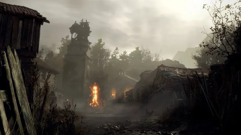 A foggy village with a burning fire in the Resident Evil 4 remake