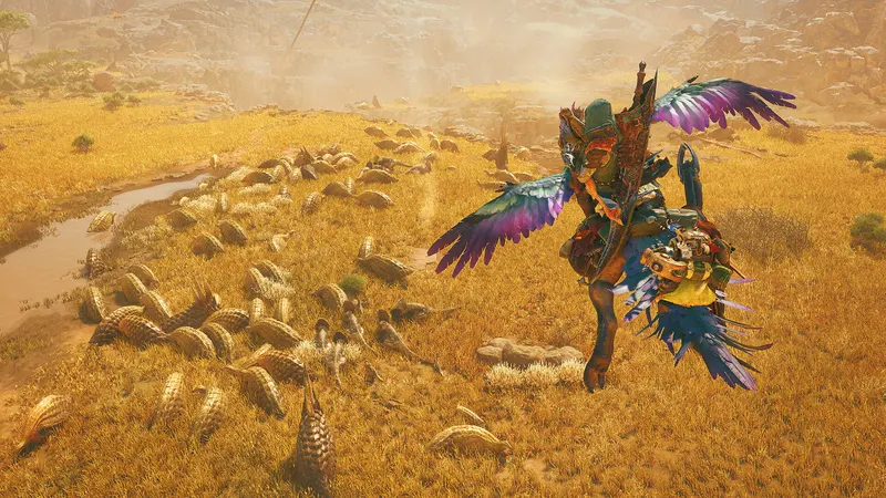 A hunter riding a feathered mount across golden grassland in Monster Hunter Wilds