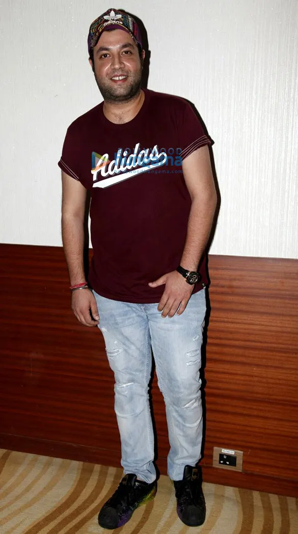 Varun Sharma in a cap and maroon t-shirt