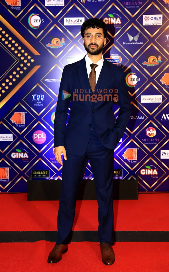 Raghav Juyal in a navy suit on a red carpet