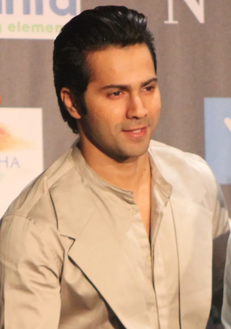 Varun Dhawan in a beige jacket at a press event