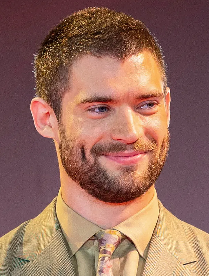 David Corenswet smiling at a red carpet fan event