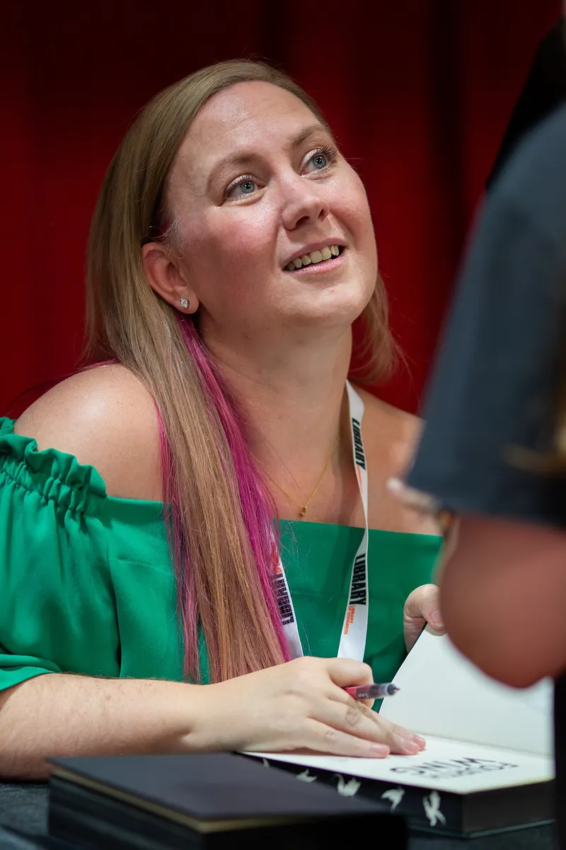 Rebecca Yarros signing books at a festival