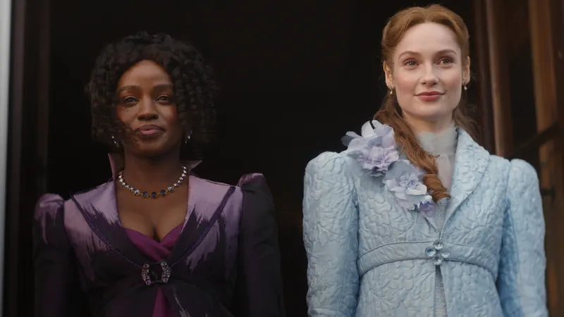 Two women in Regency gowns, one in purple and one in pale blue, standing side by side