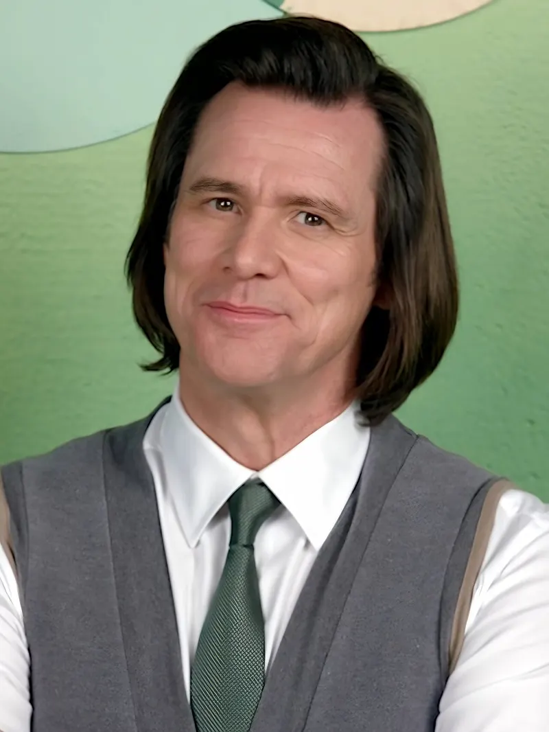 Jim Carrey with shoulder-length hair in a tie and vest