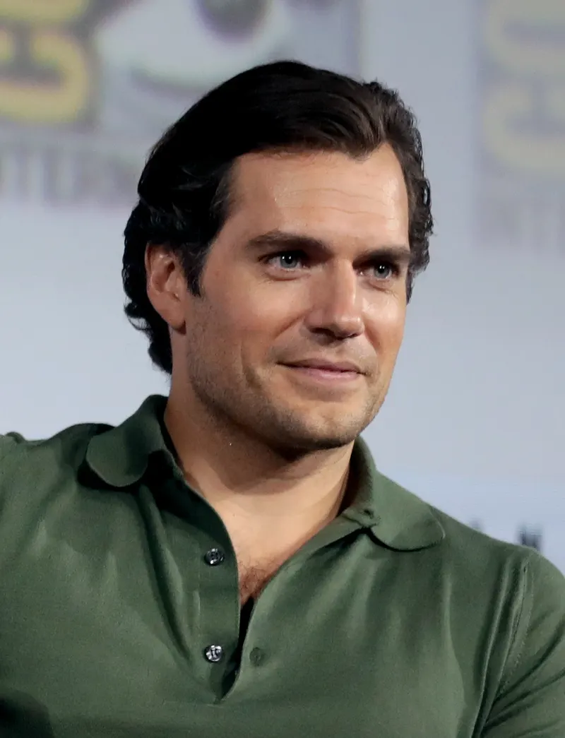 Henry Cavill in a green shirt at a convention panel