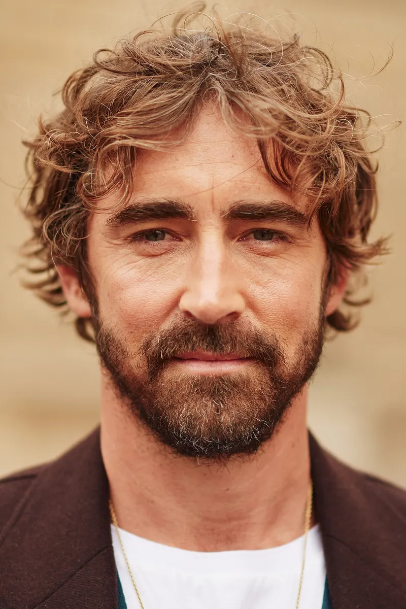Lee Pace with curly hair and a beard