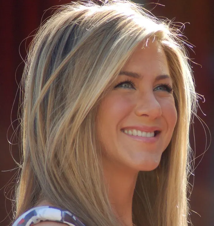 Jennifer Aniston smiling with long highlighted hair