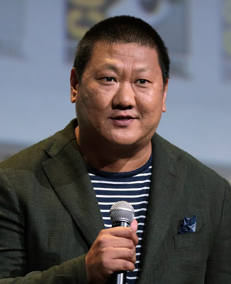 Benedict Wong speaking into a microphone at Comic-Con
