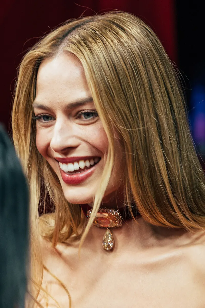 Margot Robbie smiling at a film premiere