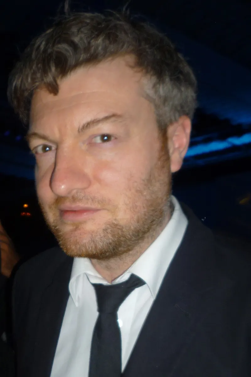 Charlie Brooker in a dark suit at an awards night