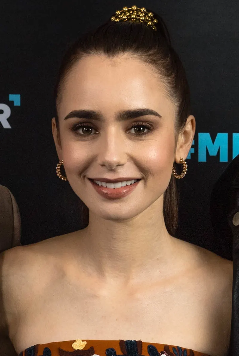 Lily Collins smiling at a film event