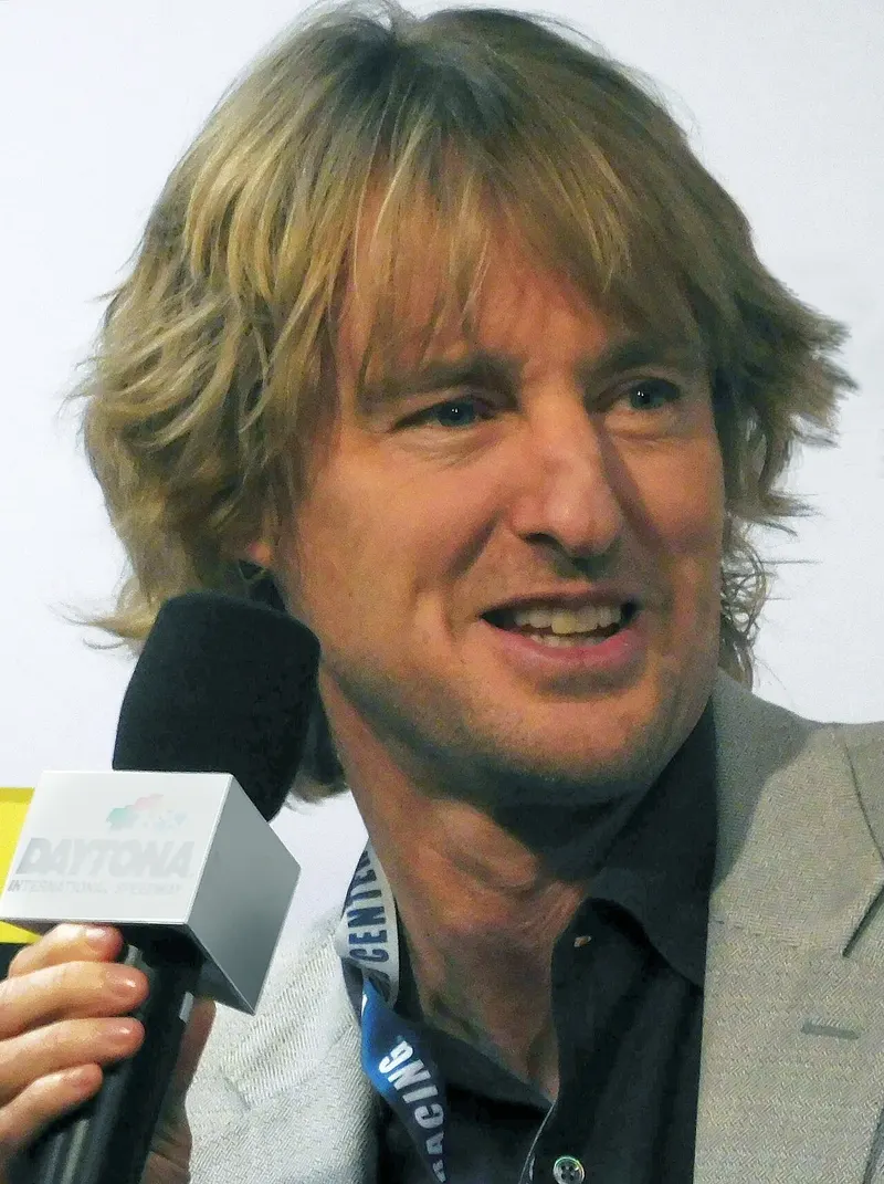 Owen Wilson speaking into a microphone