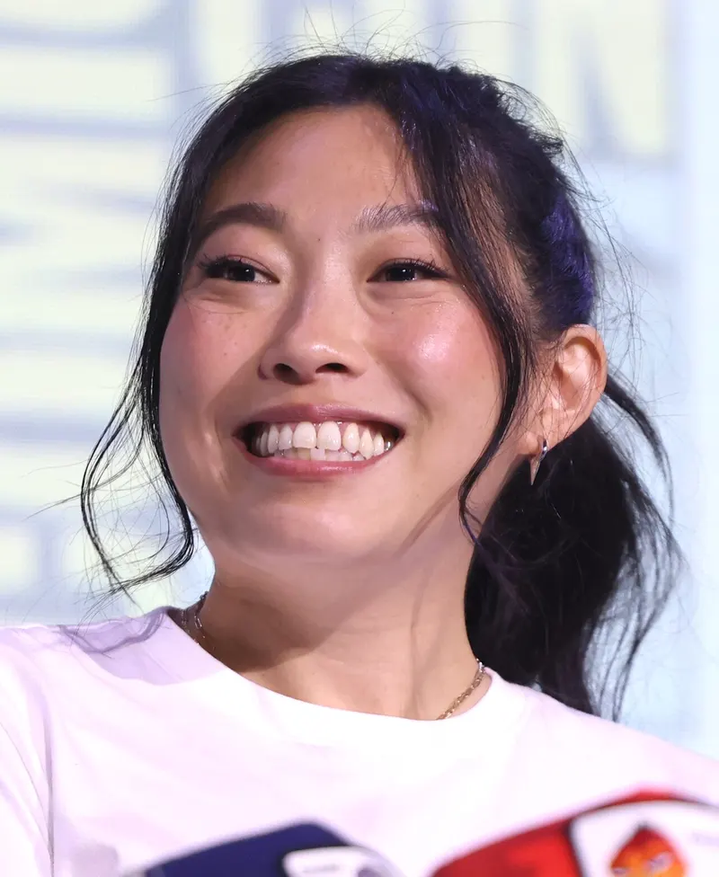 Awkwafina laughing at a Comic-Con panel