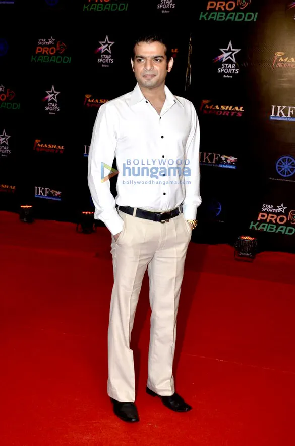 Karan Patel in a white shirt on a red carpet
