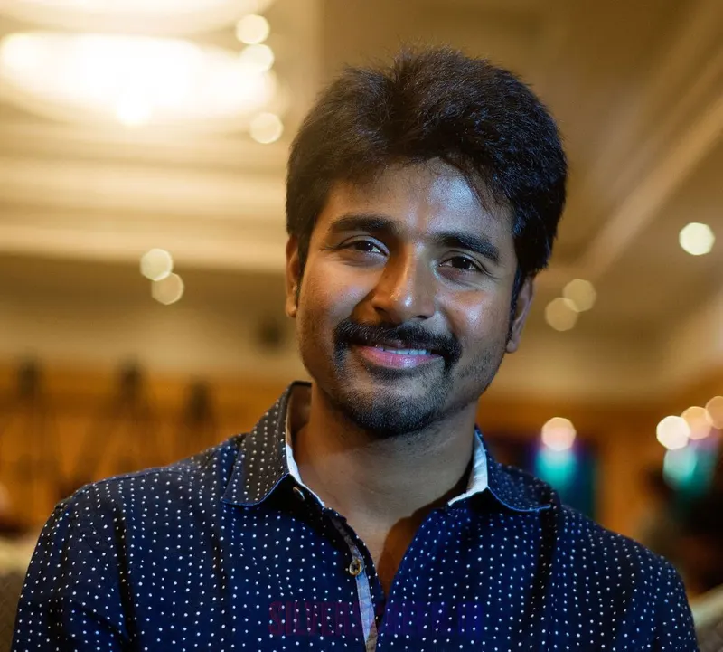 Sivakarthikeyan smiling at a media event