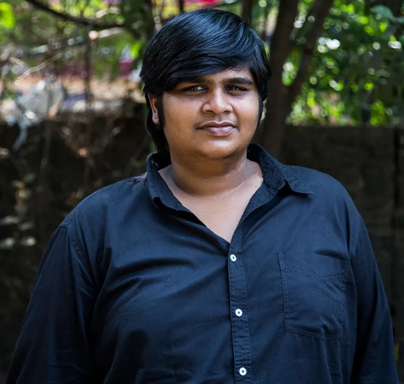 Karthik Subbaraj standing outdoors in a dark shirt