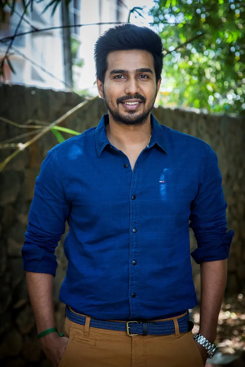Vishnu Vishal in a blue shirt standing outdoors