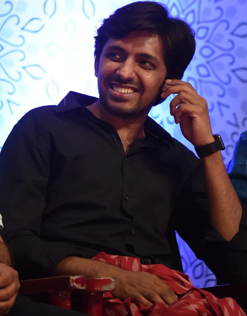 Priyadarshi smiling while seated at an event
