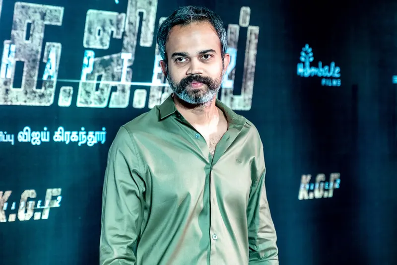 Director Prashanth Neel in a green shirt in front of a KGF backdrop