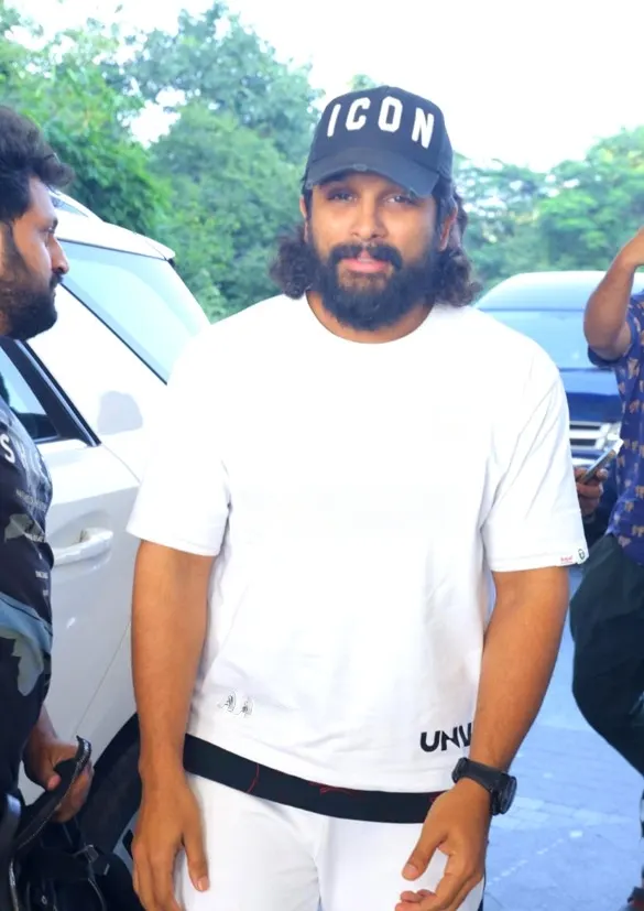 Allu Arjun in a white t-shirt and cap walking outdoors
