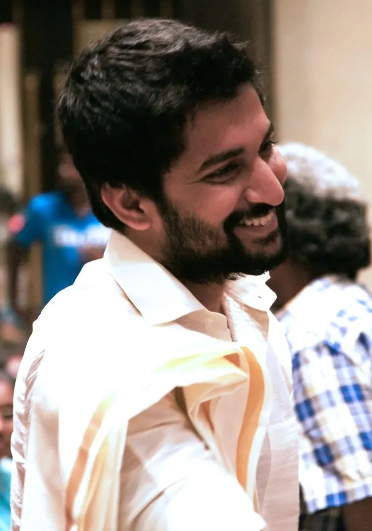 Nani laughing in a white shirt at a film event
