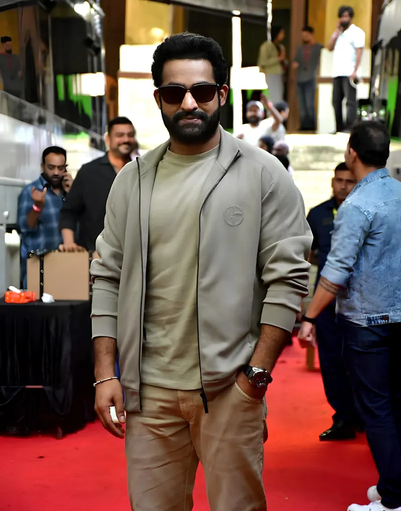 Jr NTR in sunglasses and an olive jacket at a promotional event