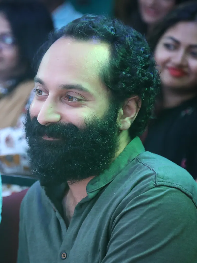 Fahadh Faasil with a full beard smiling at an event