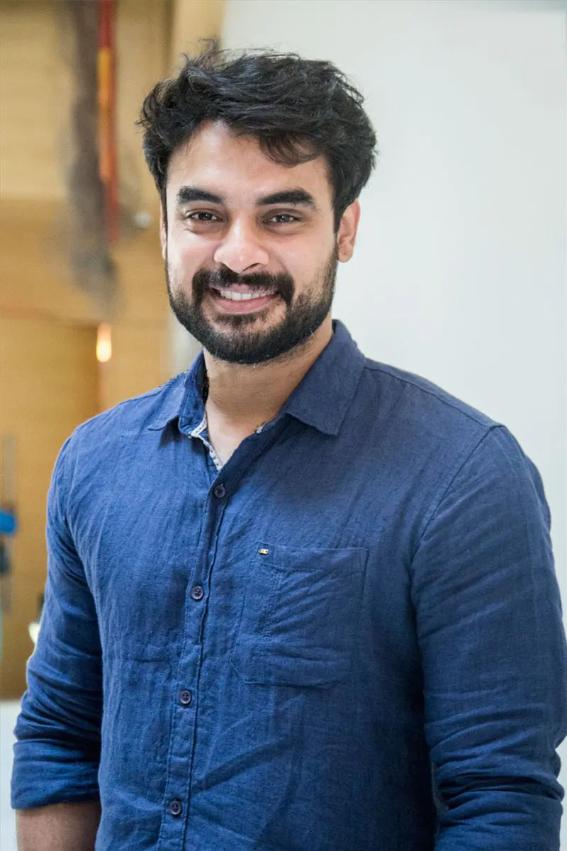 Tovino Thomas smiling in a navy shirt
