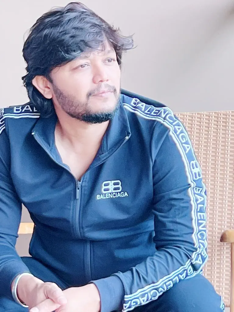 Ganesh seated in a dark tracksuit, looking to the side