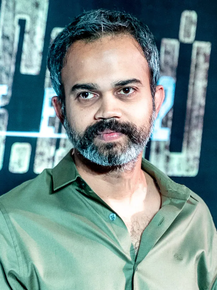 Prashanth Neel in a green shirt at a promotional event