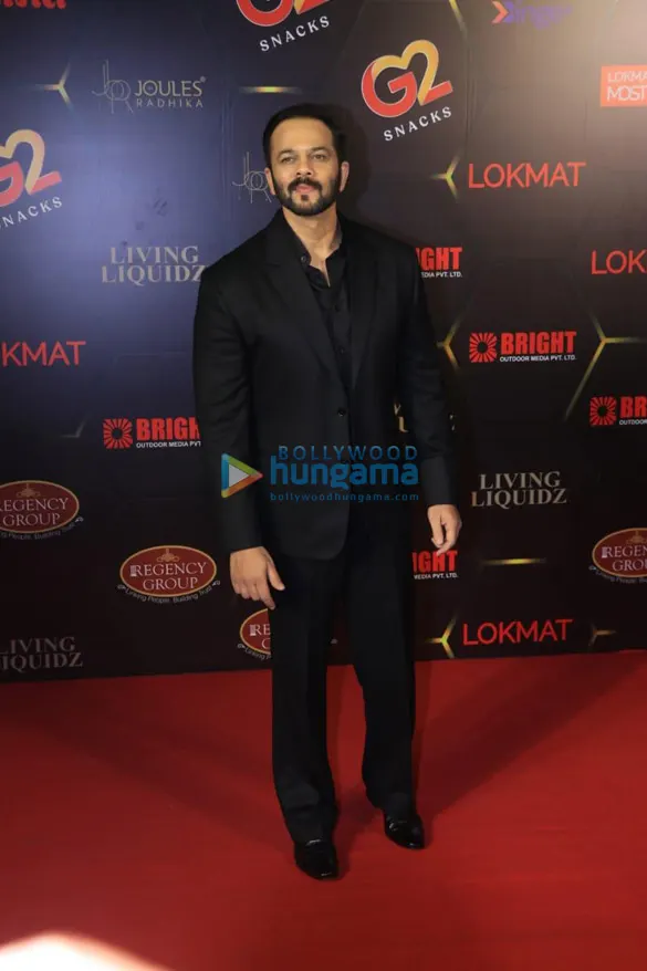 Rohit Shetty in a black suit on a red carpet