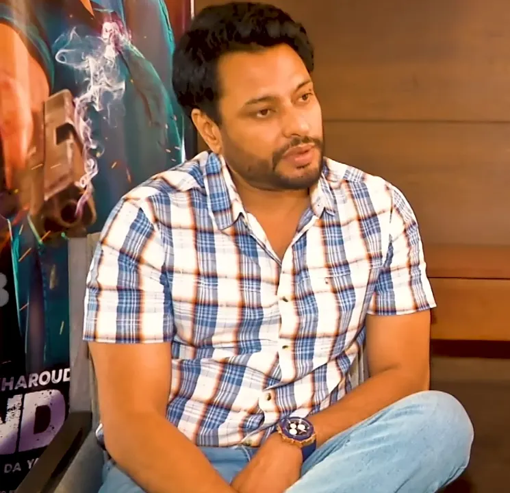 Dev Kharoud in a checked shirt during an interview
