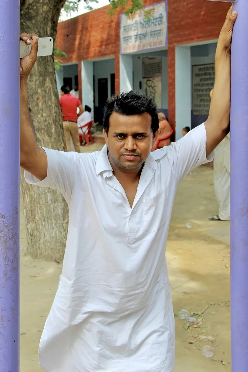 Karamjit Anmol in a white kurta in a schoolyard