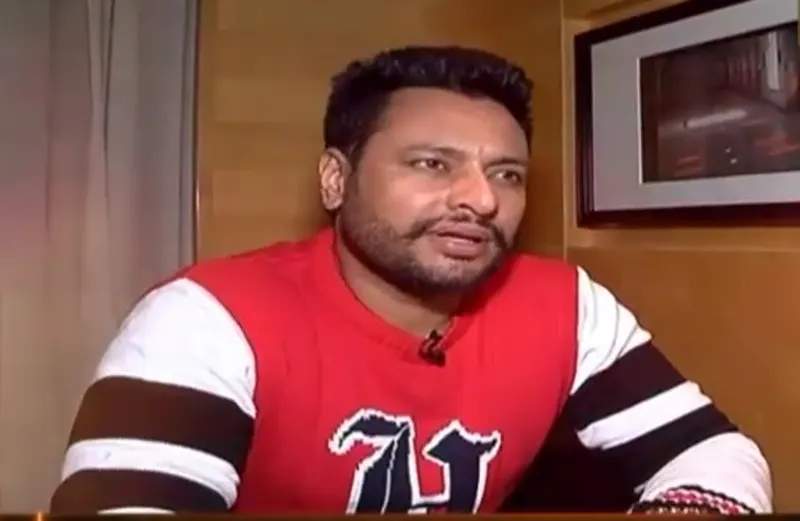 Dev Kharoud in a red jumper during an interview