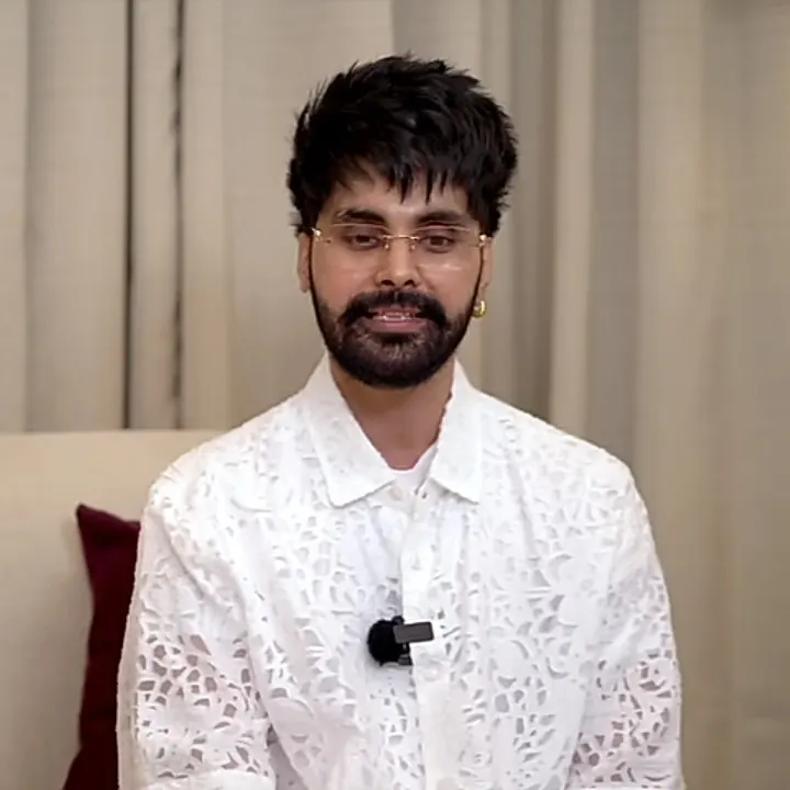 Jayy Randhawa in a white lace shirt