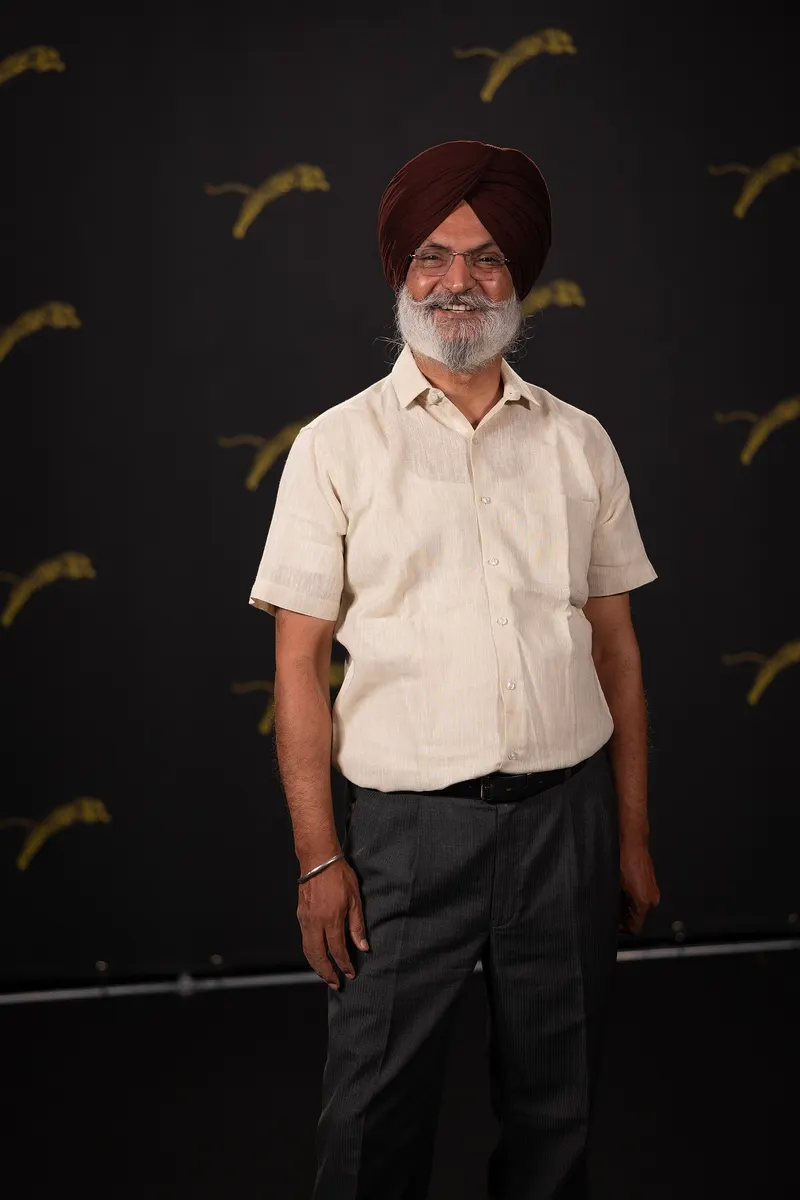 Jaswant Zafar in a turban and cream shirt smiling at Locarno