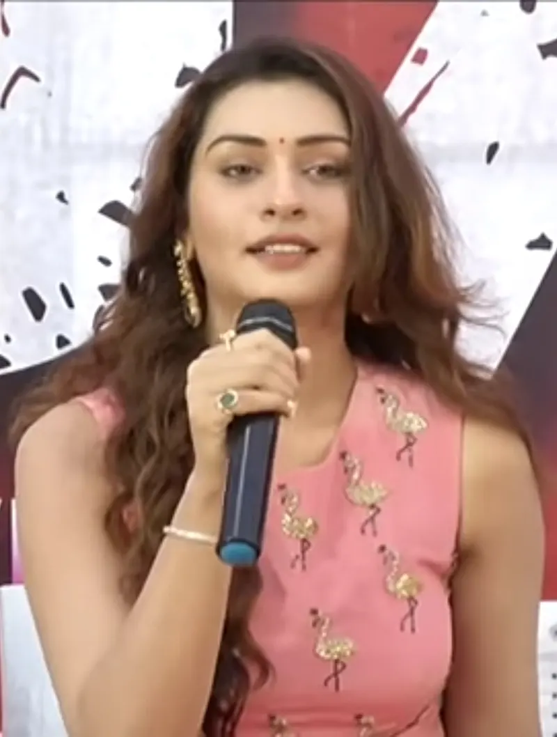 Payal Rajput speaking into a microphone