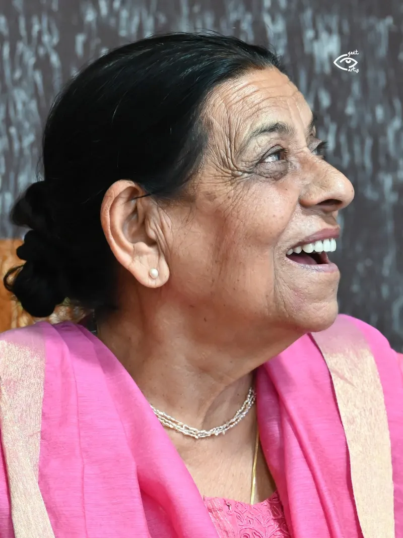 Nirmal Rishi laughing in a pink dupatta, side profile